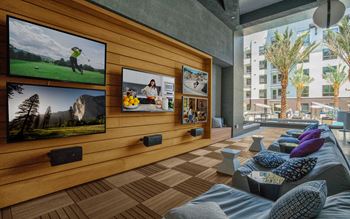 lounge area with couches and a tv on the wall